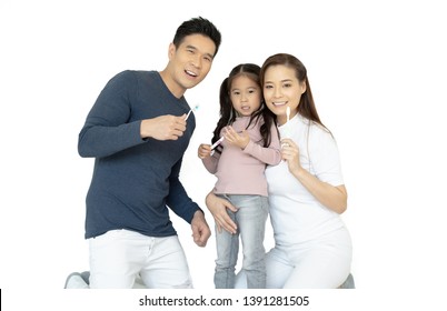 Portrait Of Smiling Happy Asian Family Brushing Teeth And Smiling At Camera Isolated On White.Healthy Teeth.