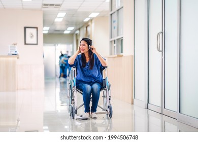 Portrait Of Smiling Happy Asian Woman Patient Sitting On Wheelchair Looking At Camera With Health Medical Care Express Trust And Insurance Concept At Hospital