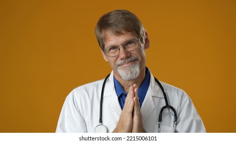 Portrait Of Smiling Happy Confident Mature Man Medical Doctor On Solid Yellow Background.