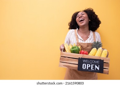 Portrait smiling happy young African woman Agricultural business owner holding wooden basket fruit and vegetable.The opening of an American business woman's fruit and vegetable shop.Brazilian female. - Powered by Shutterstock