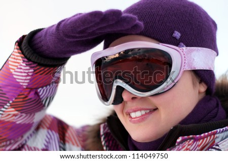 Portrait of smiling happy young woman wearing ski goggles