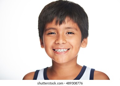 Portrait Of Smiling Hispanic Boy Isolated On White