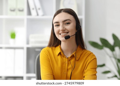 Portrait of smiling hotline operator in headset in office