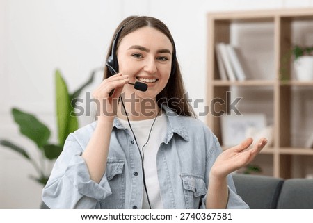 Portrait of smiling hotline operator in headset in office