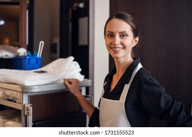 A portrait of a smiling housekeeping lady in a uniform - Shutterstock ID 1731555523