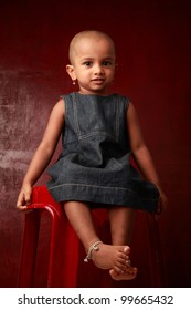 Portrait Of A Smiling Indian Girl Child In A Red Background