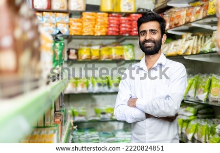 portrait of  smiling indian male in grocery with positive attitude  
