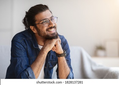 Portrait Of Smiling Indian Man With Eyeglasses And Braces In Home Interior, Handsome Pensive Western Guy Daydreaming And Looking Away, Thinking About Something, Selective Focus With Copy Space - Shutterstock ID 1828137281