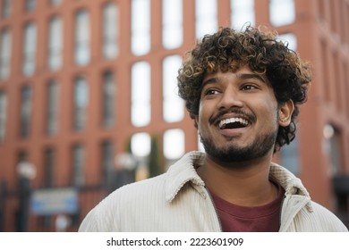 Portrait Of Smiling Indian Man Wearing Casual Clothing Looking Away, Copy Space. Happy Handsome Asian Tourist With Curly Hair Enjoying City, Travel Concept 