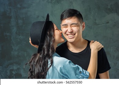 Portrait of smiling Korean couple on a gray