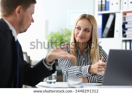 Portrait of smiling lady working in modern office. Cheerful business woman discussing advantages disadvantages of contract with partner. Biz concept. Blurred background