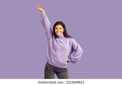 Portrait Of Smiling Latino Girl Isolated On Violet Studio Background Make Dancer Moves. Funny Happy Young Ethnic Woman Have Fun Dancing Feeling Joyful And Optimistic. Hobby Concept.