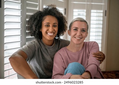 Portrait of smiling lesbian couple at home - Powered by Shutterstock