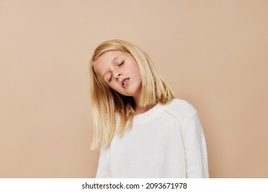 Portrait Of A Smiling Little Cutie With Blond Hair Posing Studio