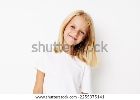 Portrait of a smiling little cutie fashionable baby clothes posing studio