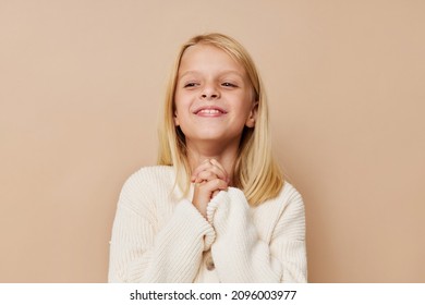 Portrait Of A Smiling Little Cutie In A White Sweater Cropped View