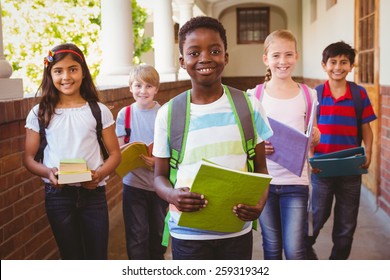 Portrait of smiling little school kids in school corridor - Shutterstock ID 259319342