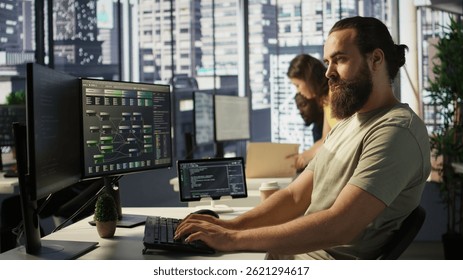 Portrait of smiling machine learning infrastructure engineer developing algorithms to learn from data. Cheerful man in office training and deploying large scale deep learning models, camera B