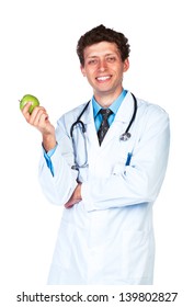Portrait of a smiling male doctor holding green apple on white background