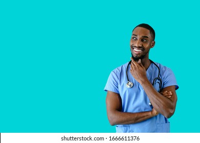 Portrait Of A Smiling Male Doctor Or Nurse Thinking And Looking To Side At Copy Space