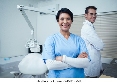 Portrait of smiling male and female dentists