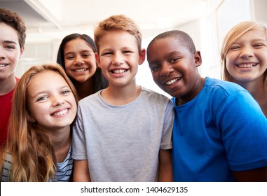 Portrait Of Smiling Male And Female Students In Grade School Classroom