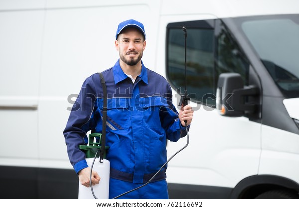 Portrait Of A Smiling Male Pest Control Worker\
Standing In Front Of\
Vehicle