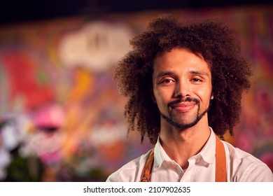 Portrait Of Smiling Male Server Working Night Shift In Bar Restaurant Or Club