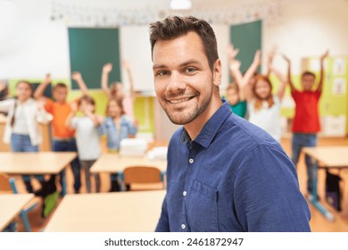 Portrait of smiling male teacher with students in background at school - Powered by Shutterstock