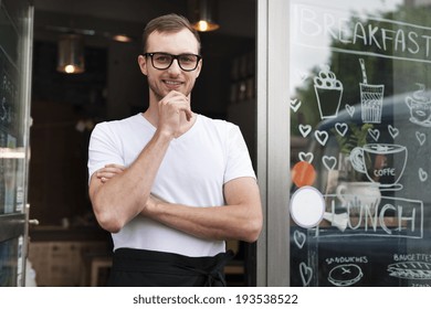 Portrait of smiling male waiter outside the cafe  - Powered by Shutterstock