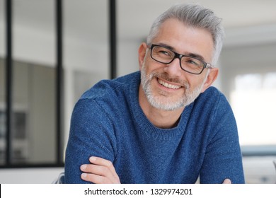 Portrait Of Smiling Man With Grey Hair And Glasses