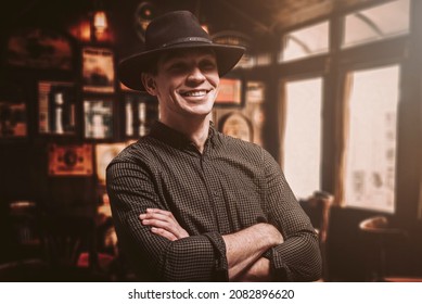 Portrait of a smiling man in a hat. Cowboy style. Saloon. Mixed media