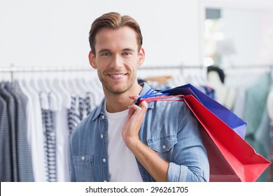 Portrait Of A Smiling Man With Shopping Bags At The Clothing Store