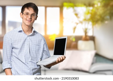 Portrait of smiling man using computer. Adult male watching video, taking break