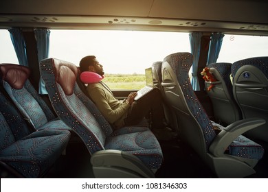 Portrait of smiling man using laptop computer in bus travel