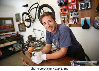 Portrait Of Smiling Man Working In Bike Rental Shop