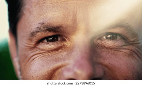 Portrait of a smiling man with wrinkles. Macro Close Up of male person with lens flare sunlight outdoors. Happy emotion expression - Powered by Shutterstock