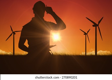 Portrait Of Smiling Manual Worker Holding Clipboard Against Sky And Field