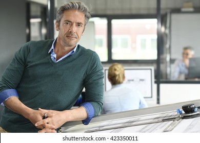 Portrait Of Smiling Mature Architect In Office