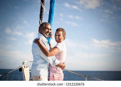 Portrait Of Smiling Mature Couple Hugging On Boat Deck.