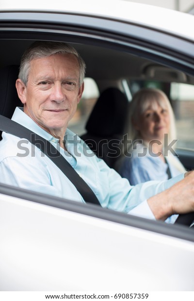 Portrait
Of Smiling Mature Couple On Car Journey
Together
