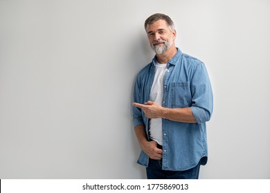 Portrait Of Smiling Mature Man Standing On White Background.