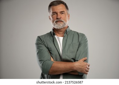 Portrait of smiling mature man standing on white background - Shutterstock ID 2137526587