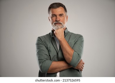 Portrait of smiling mature man standing on white background - Shutterstock ID 2137526595