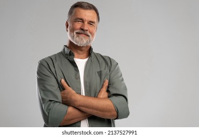 Portrait of smiling mature man standing on white background. - Shutterstock ID 2137527991