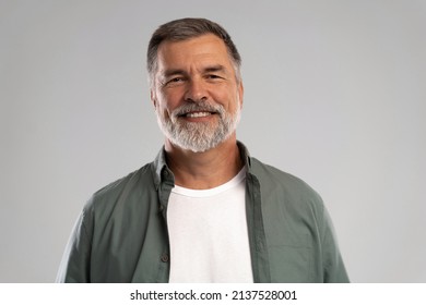 Portrait of smiling mature man standing on white background. - Shutterstock ID 2137528001