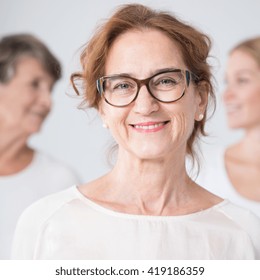 Portrait Of Smiling Mature Woman In Glasses With Family