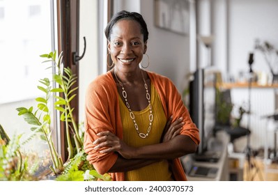 Portrait of a smiling mature woman standing in her apartment - Powered by Shutterstock