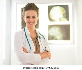 Portrait Of Smiling Medical Doctor Woman In Front Of Fluorography Lightbox