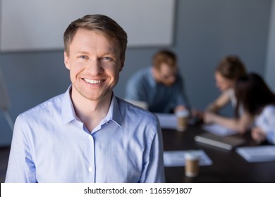 Portrait Of Smiling Middle-aged Male Employee Posing During Company Team Meeting In Boardroom, Confident Happy Businessman Looking In Camera, Making Picture For Corporate Catalogue During Briefing